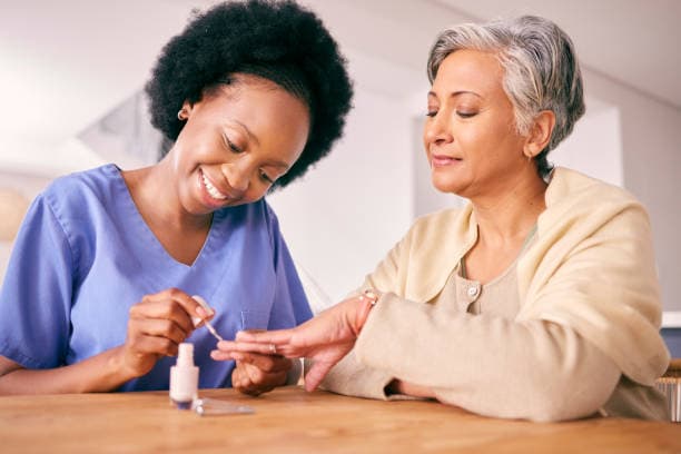 Caregiver and client smiling together